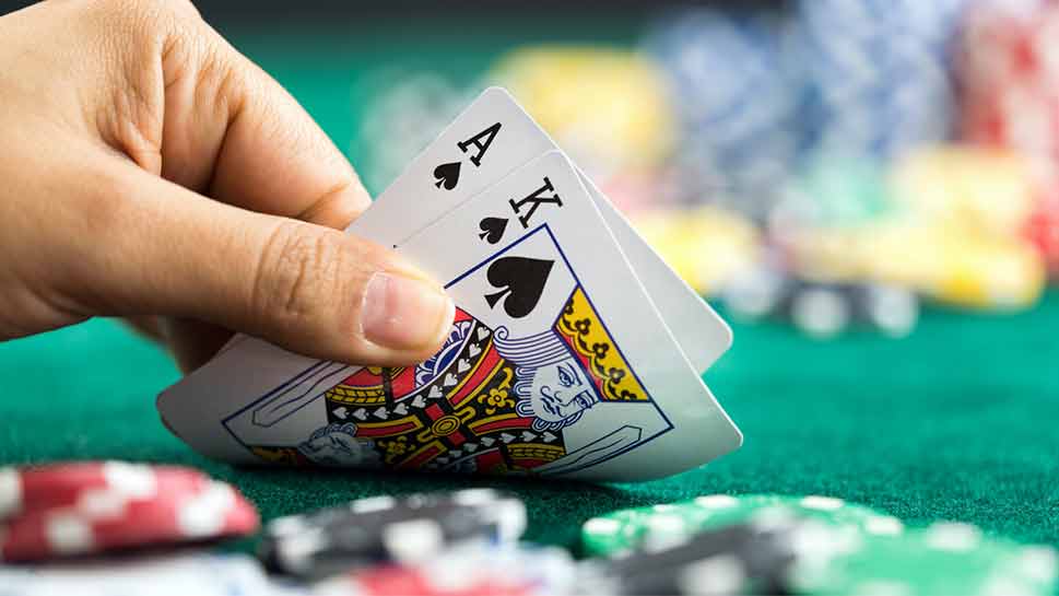 Blackjack game with man holding cards